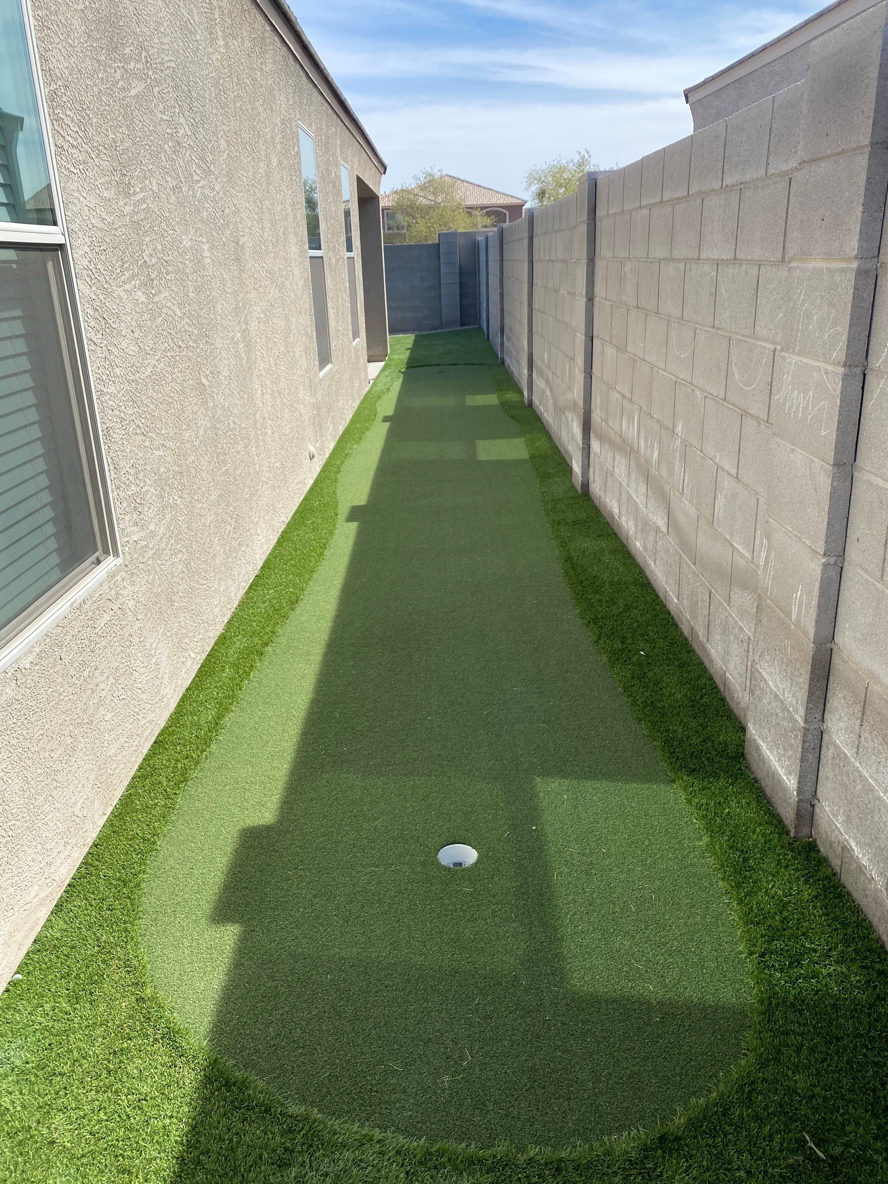 Narrow side yard artificial turf after professional cleaning by Zeo Turf Cleaning